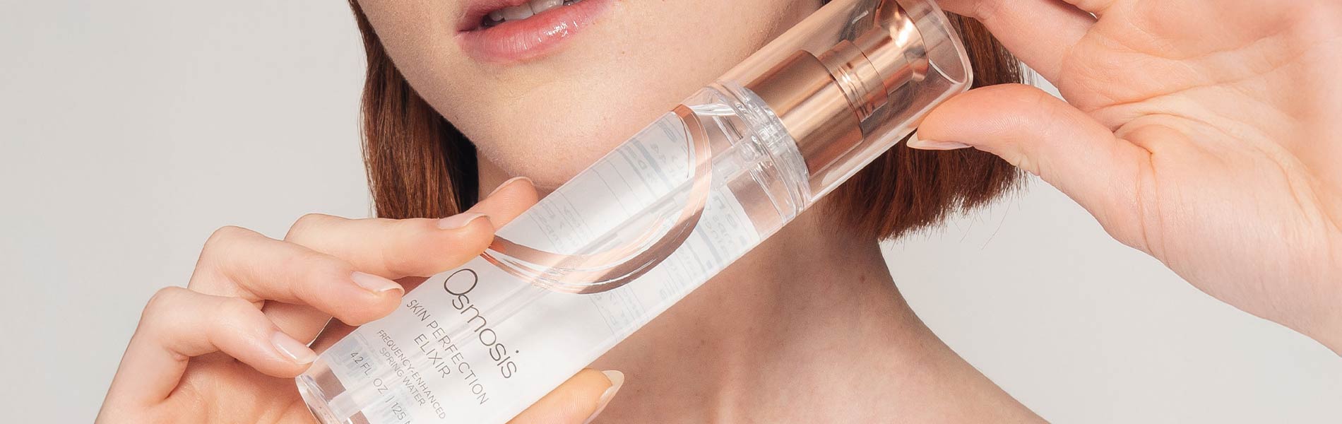 Woman holding an Osmosis Skin Perfection Elixir