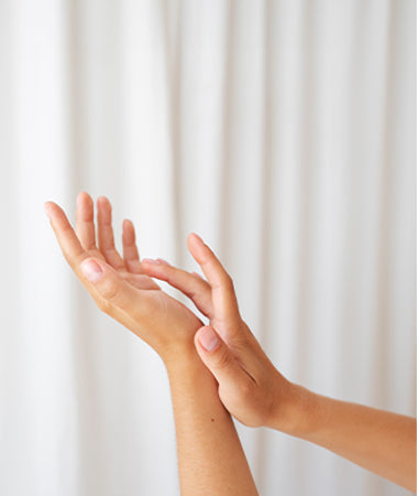 Hands in front of a white curtain