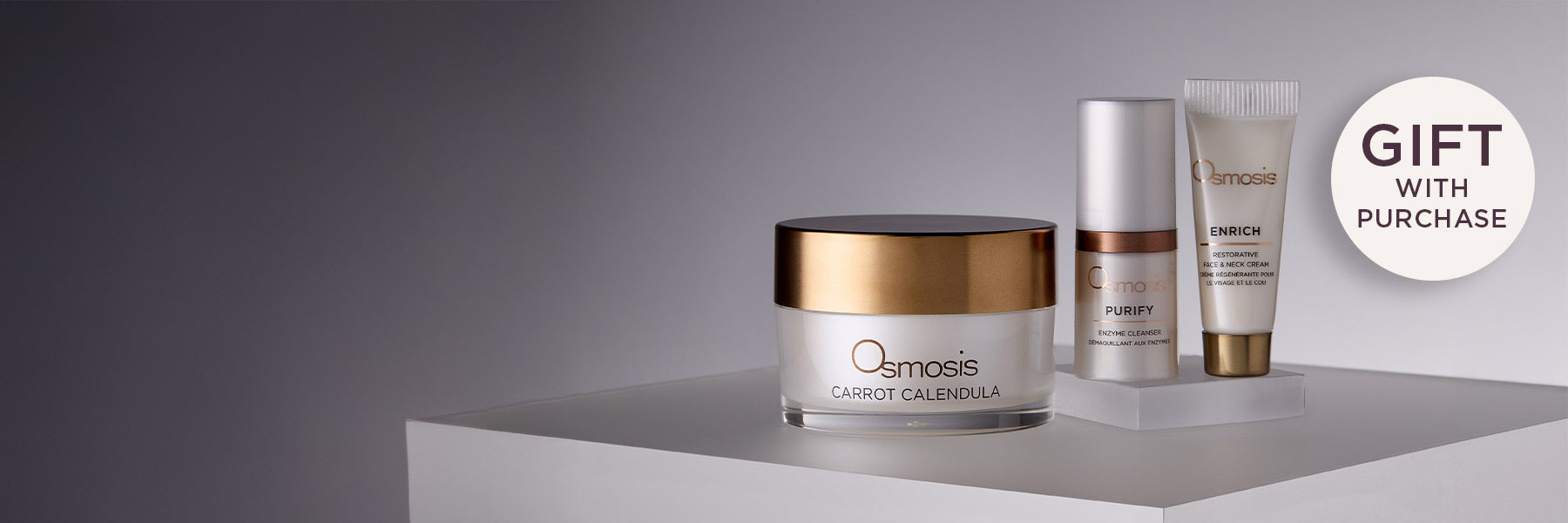 Osmosis Carrot Calendula Mask Purify Enzyme Cleanser Enrich Face and Neck Cream on a grey background with a Gift with Purchase call out