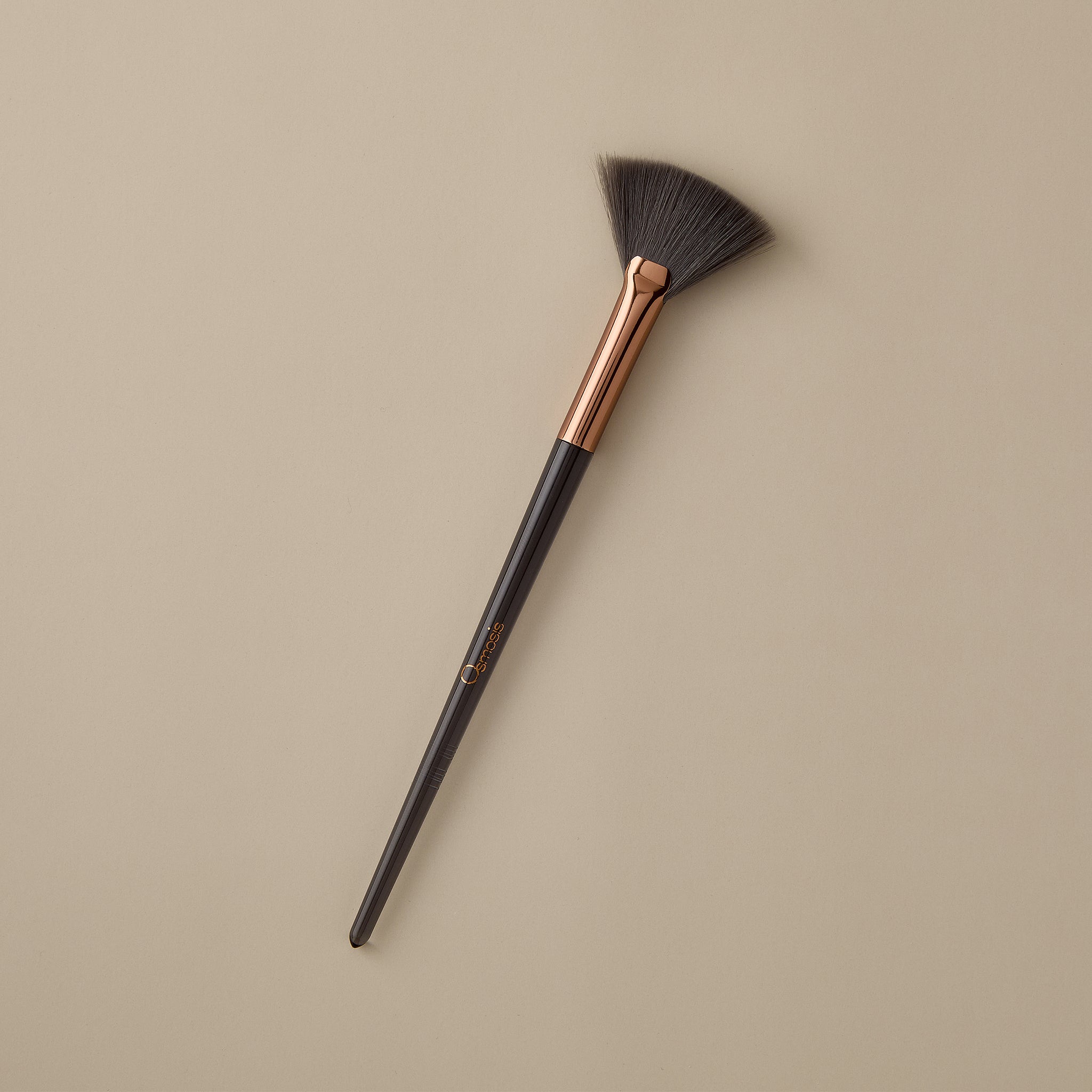 Osmosis Feathering Fan Skincare Brush on beige background