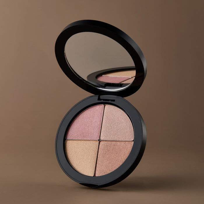 Osmosis Highlighting Quad Makeup palette with four colors on a dark tan background