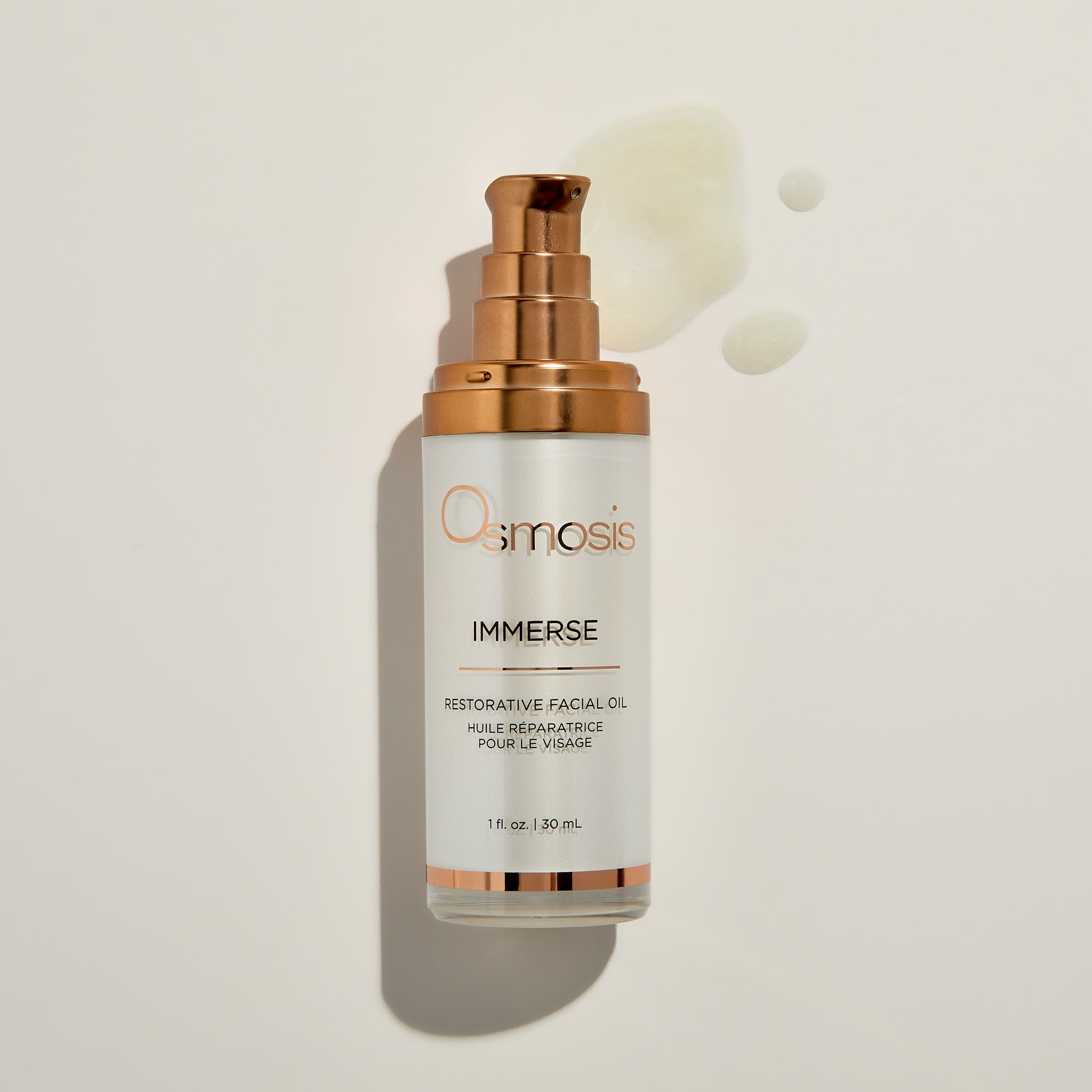 Osmosis Immerse Facial Oil with product swatch on a beige background