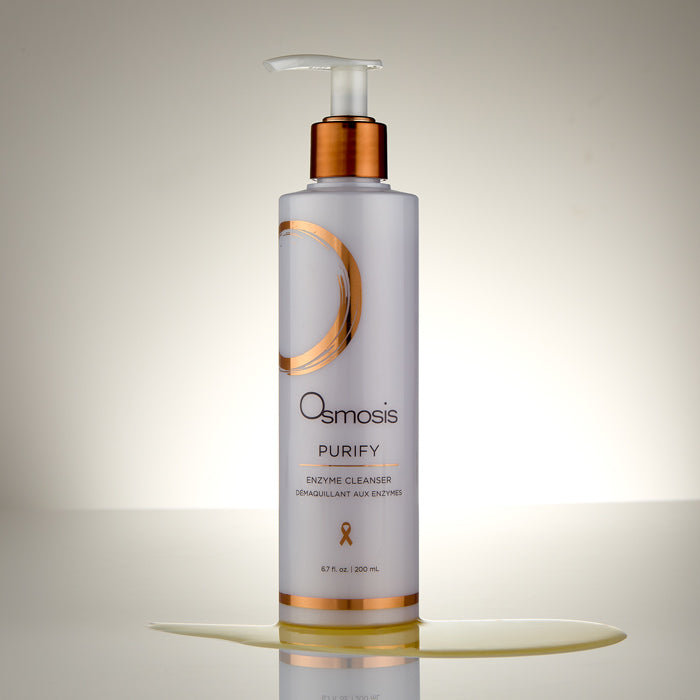 Osmosis Purify Enzyme Cleanser bottle on a reflective surface with a neutral background