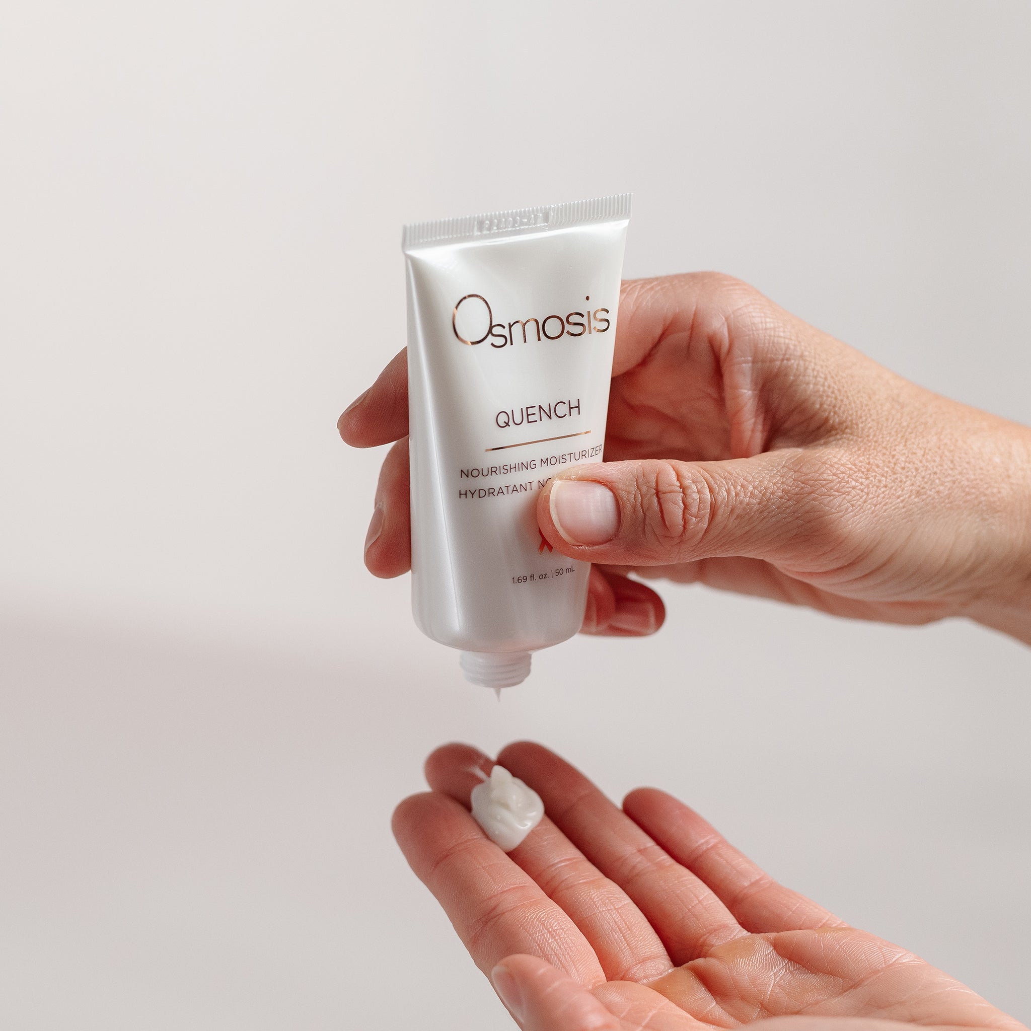 Osmosis Quench Moisturizer being squeezed onto hand