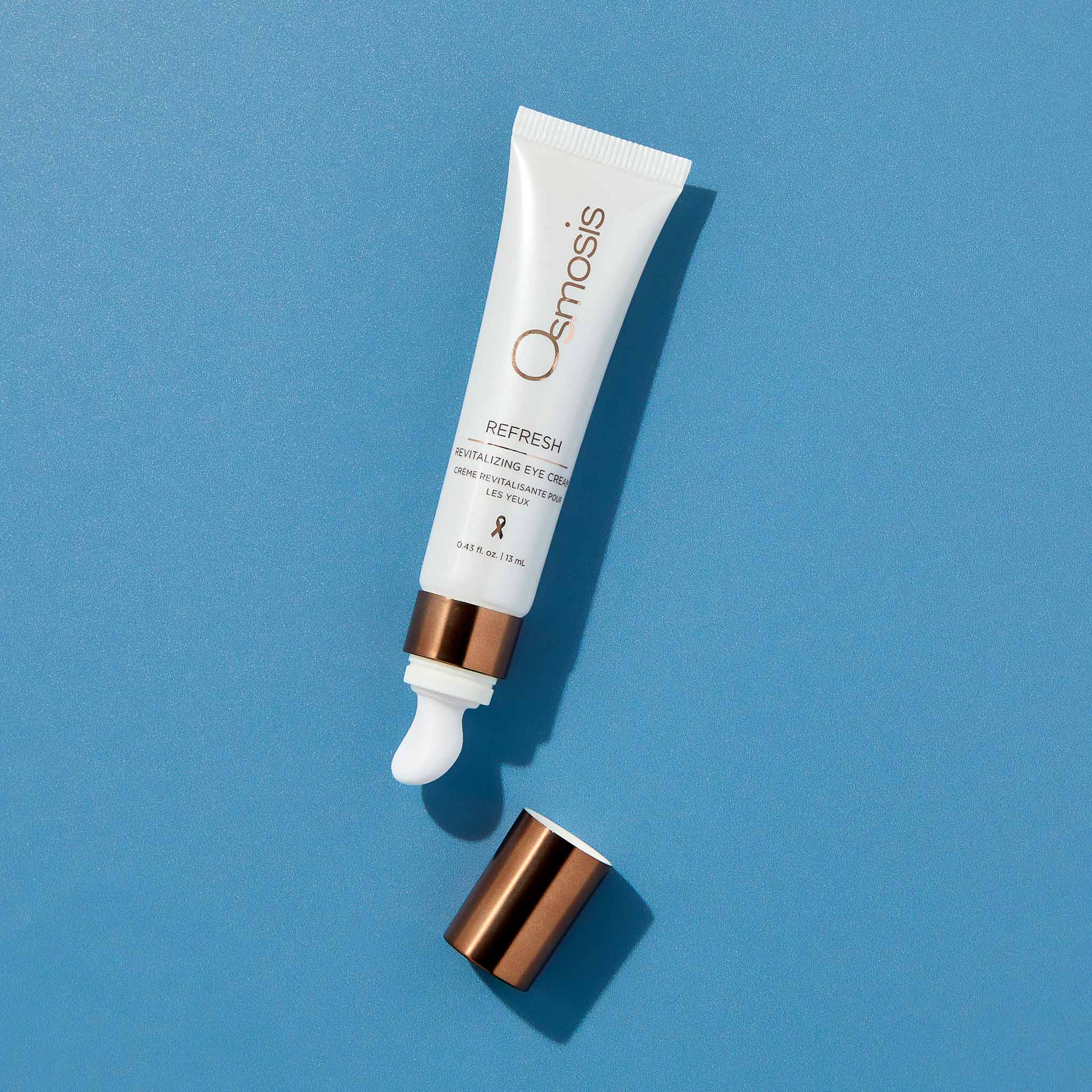 Osmosis Refresh tube with applicator on a blue background
