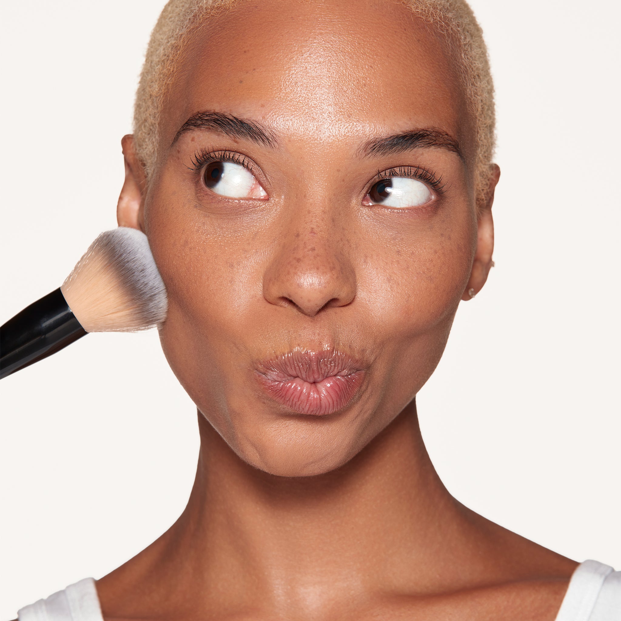 Osmosis Makeup Powder Brush being used on cheek