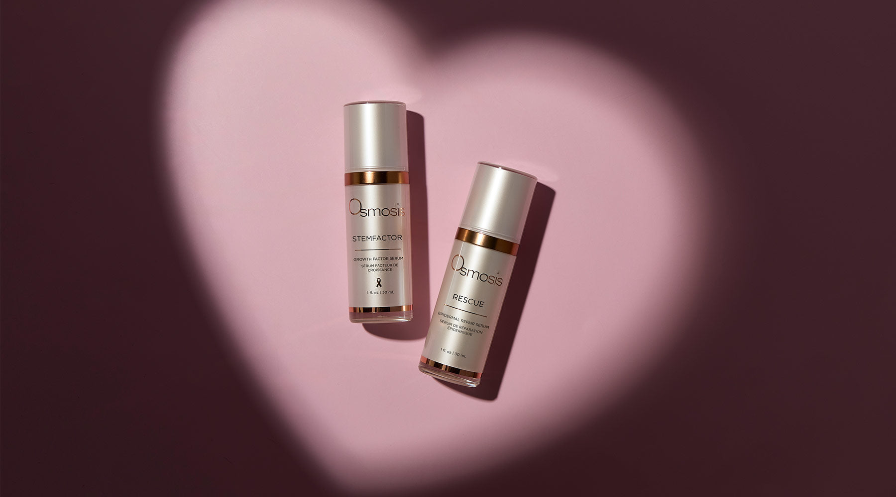 Two white skincare bottles sitting inside a beam of light that is in the shape of a heart