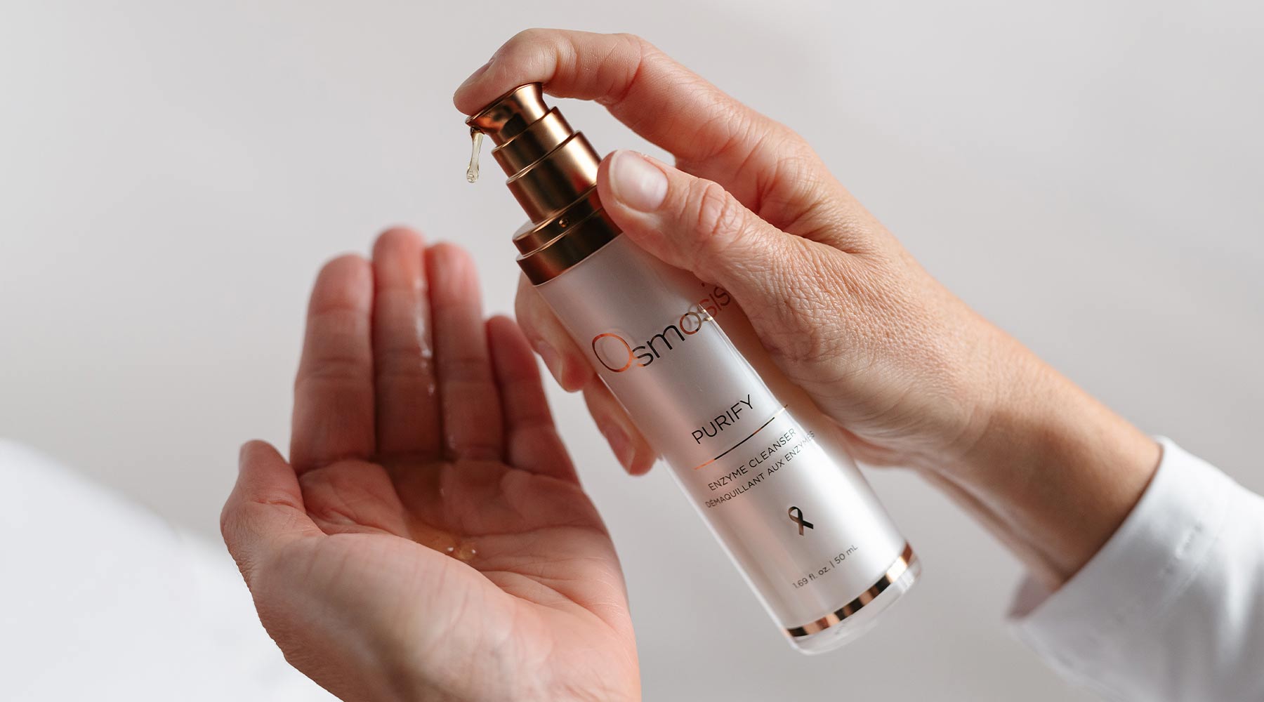 Hands holding Enzyme Cleanser