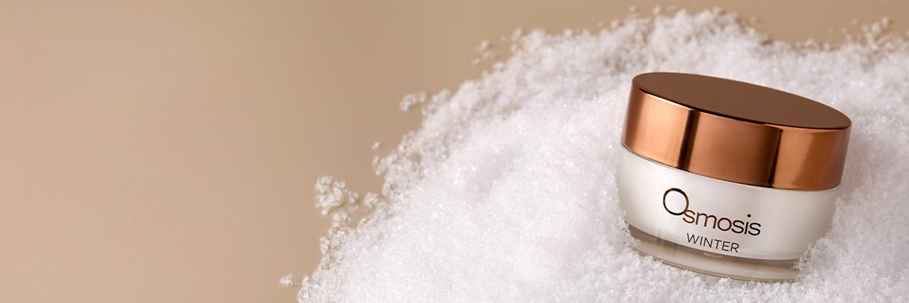 Osmosis Winter skincare product on a textured white surface with a beige background
