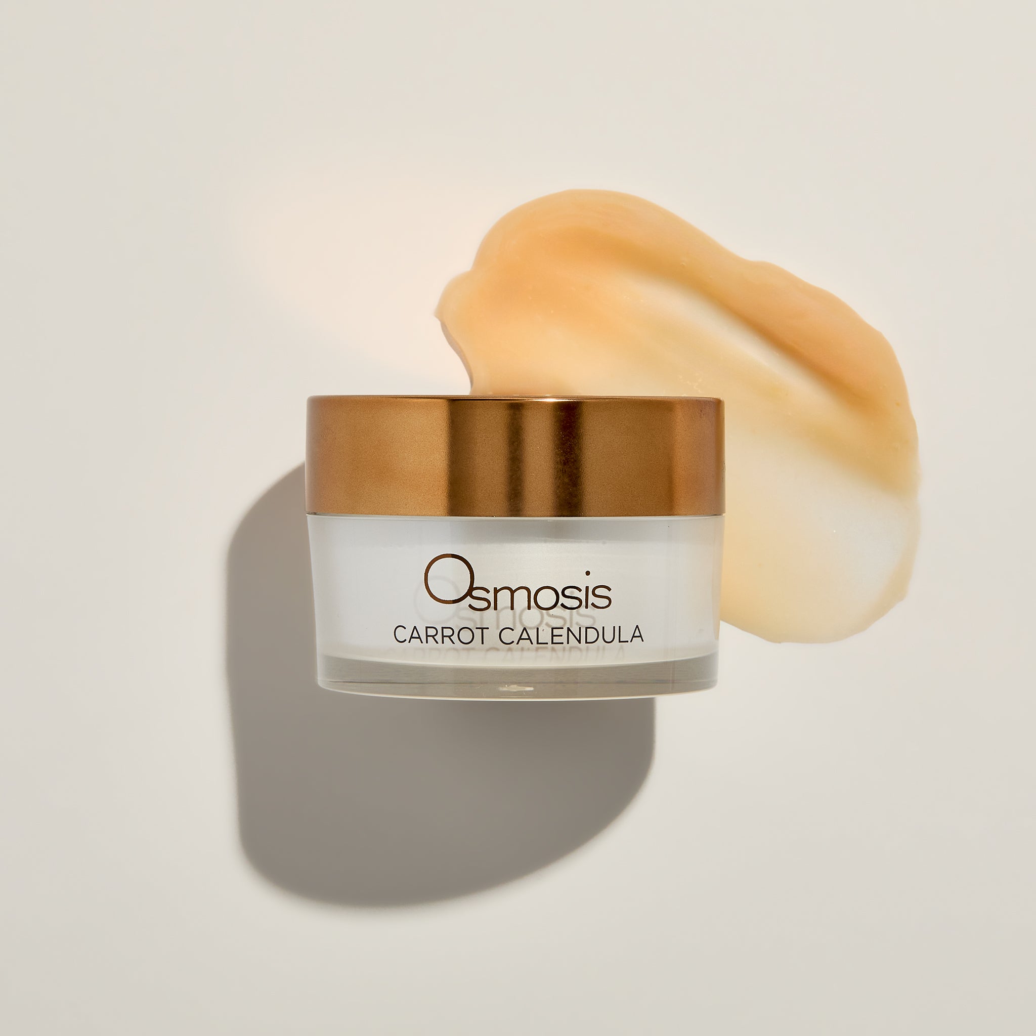 Osmosis Carrot Calendula Mask with product swatch on a beige background