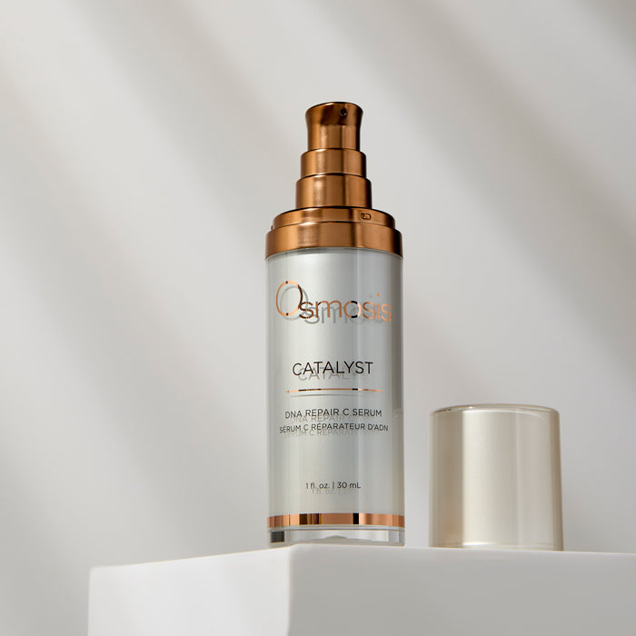 Osmosis Catalyst DNA Repair C Serum bottle with gold cap on a light gray background