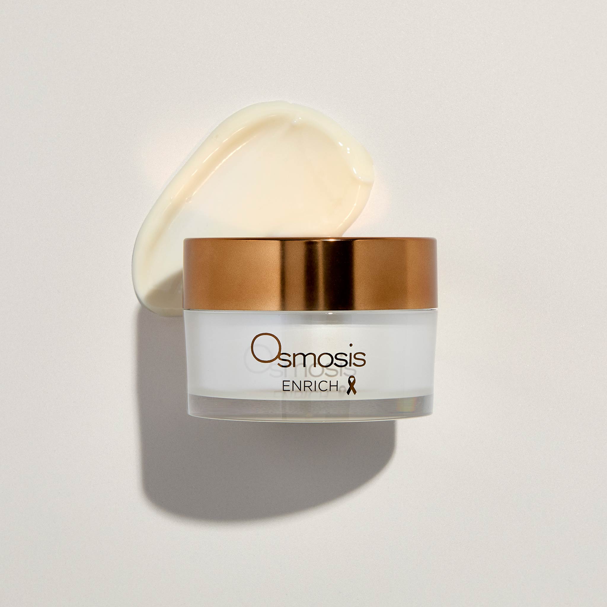 Osmosis Enrich Moisturizer with product swatch on a beige background