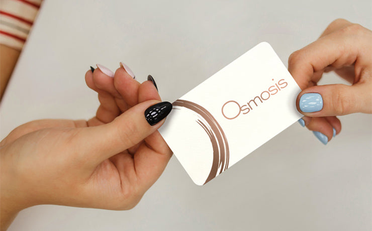 2 hands sharing an Osmosis Gift Card
