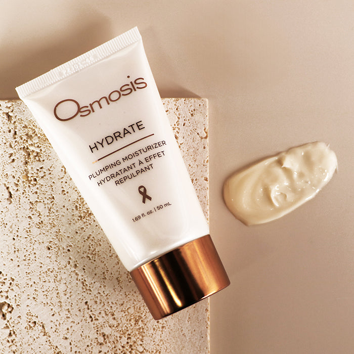 Osmosis Hydrate Moisturizer with product swatch on a stone and tan background