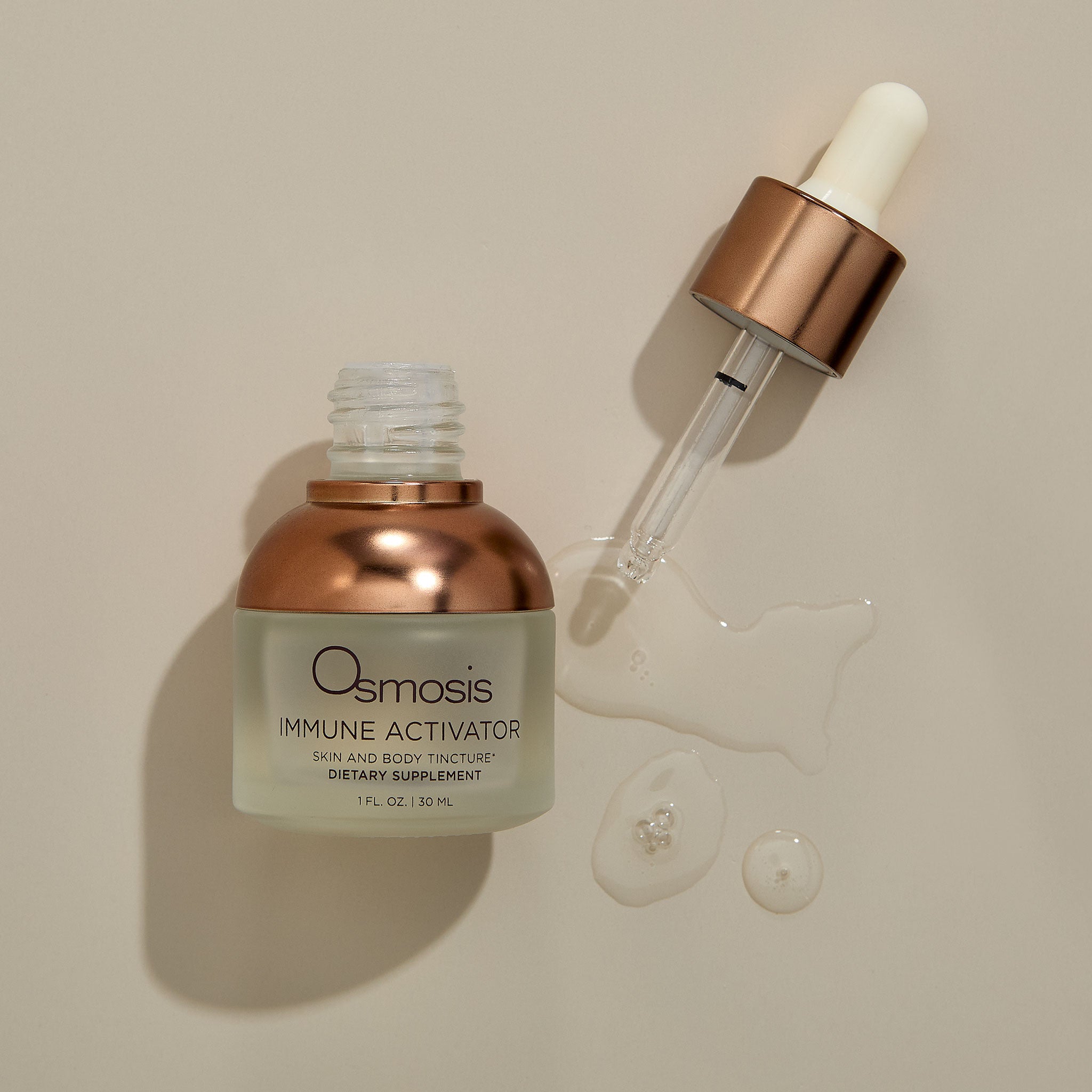 Osmosis Immune Activator Elixir with product swatch on a tan background