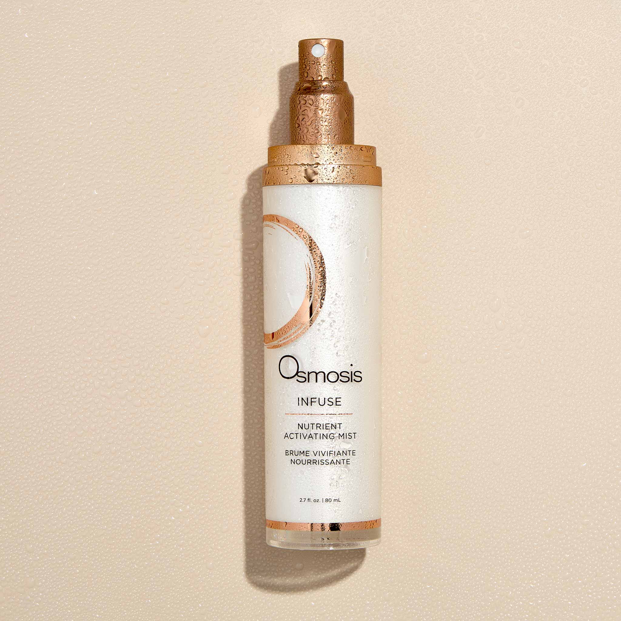 Osmosis Infuse Nutrient Activating Mist with spray on bottle on a beige background