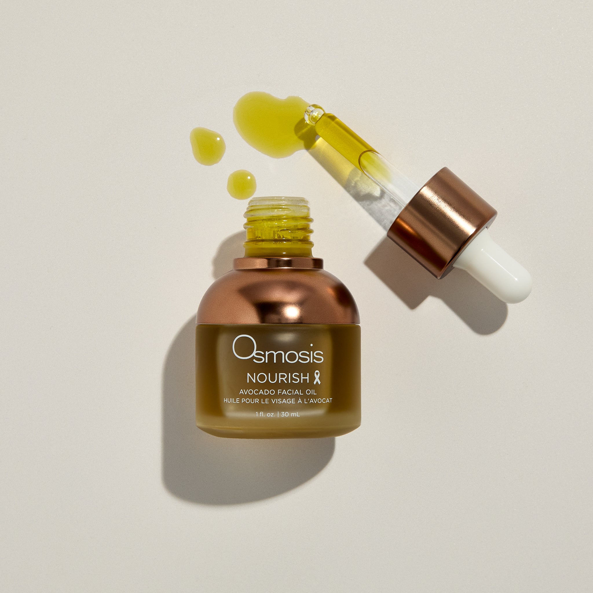 Osmosis Nourish Avocado Facial Oil with product swatch on a beige background