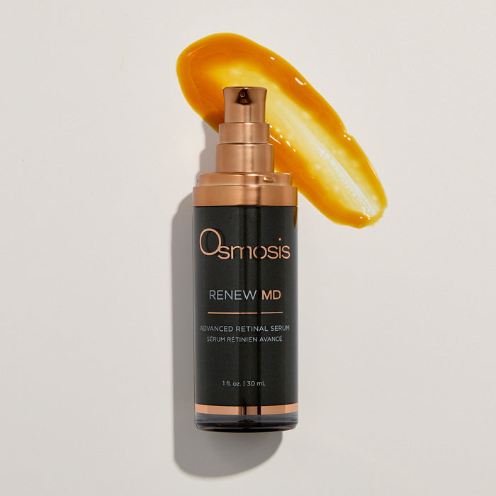 Osmosis Renew MD serum bottle with a smear of serum on a light background