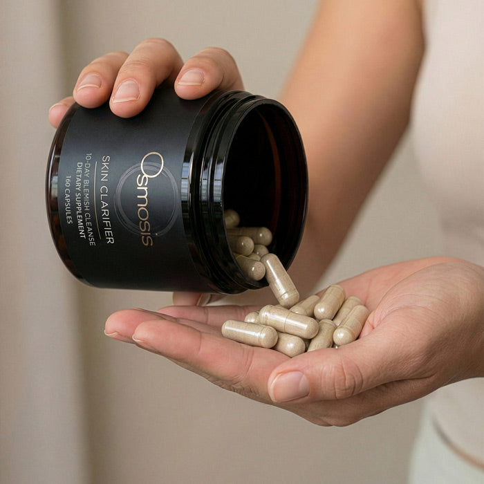 Osmosis Clarity Clarifier jar open with capsules dispensing into hand