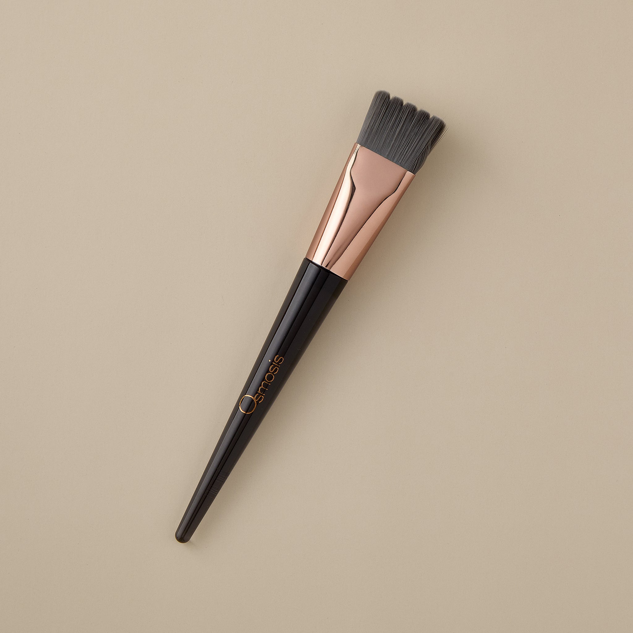 Osmosis Stimulating Scallop Skincare Brush on beige background