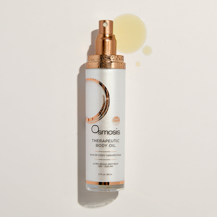 Osmosis Therapeutic Body Oil bottle on a light beige background