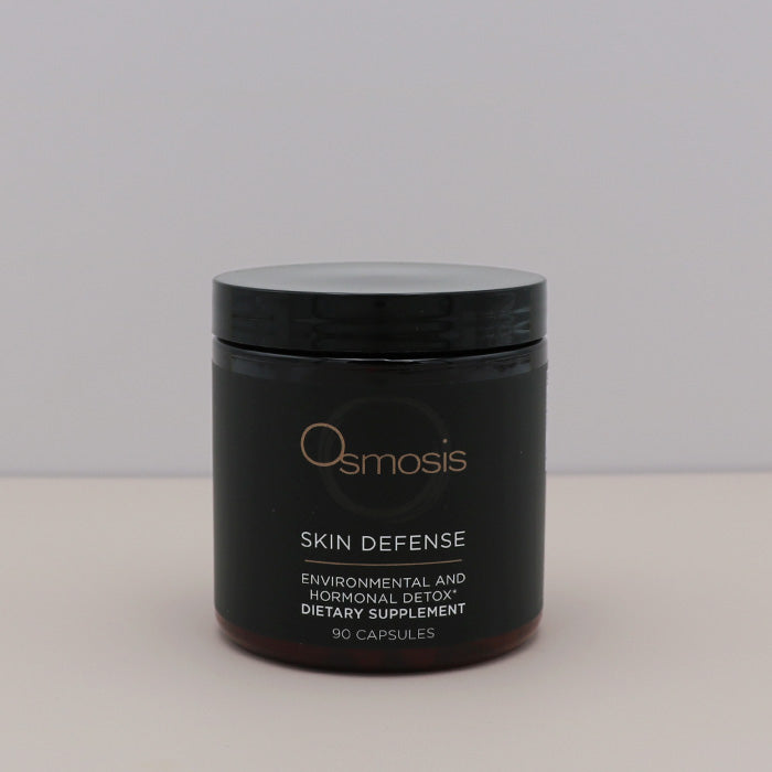 Black container of Osmosis Skin Defense dietary supplement on a light gray background