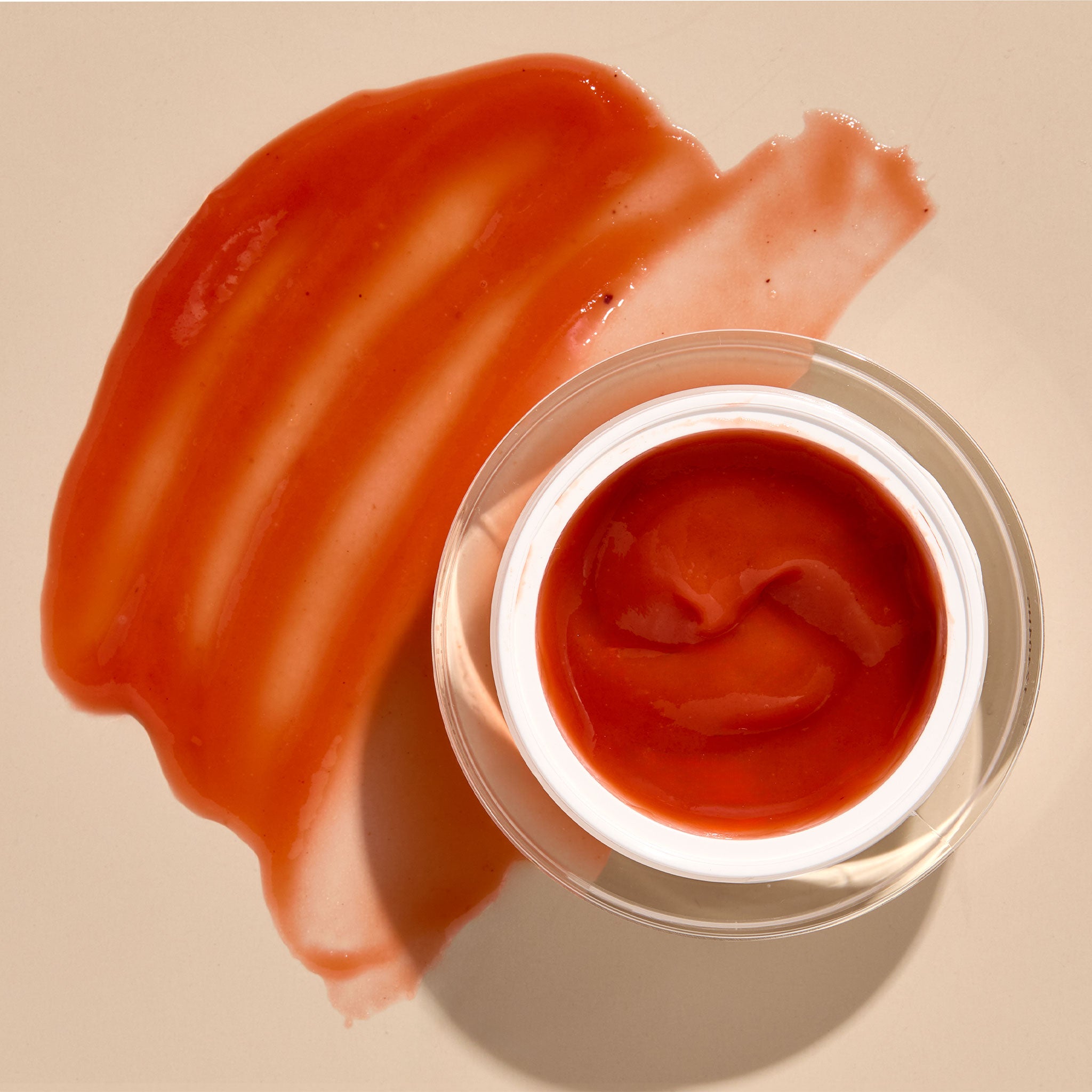 Osmosis Winter Enzyme Warming Mask with product swatch on a tan background