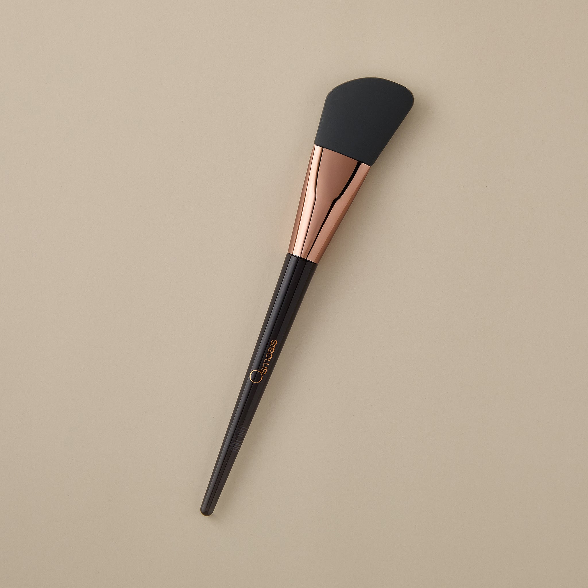 Osmosis Sculpting Silicone Skincare Brush on beige background
